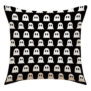 Close-up of linen fabric texture on black Halloween pillowcase with white ghost patterns