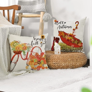 Close-up of linen Thanksgiving pillow covers with maple leaves and pumpkin designs