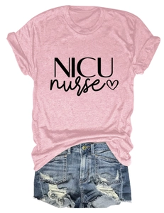 Flat lay of pink NICU nurse t-shirt with blue distressed denim shorts on white background