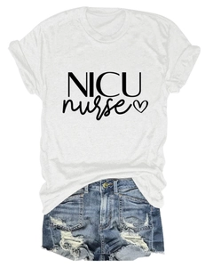 Flat lay of a white NICU nurse t-shirt with heart graphic paired with denim shorts