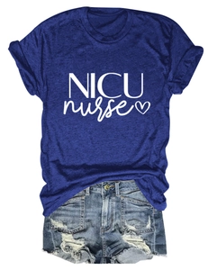 Flat lay of a navy blue NICU nurse t-shirt with heart graphic and denim shorts