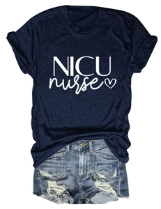 Flat lay of a navy blue NICU nurse T-shirt paired with ripped denim shorts on white background