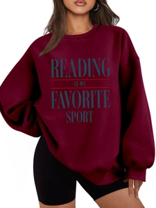 Close-up of burgundy drop shoulder sweatshirt with Reading Is My Favorite Sport text
