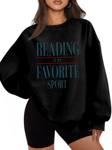 Close-up of Reading Is My Favorite Sport text on black crewneck sweatshirt detail