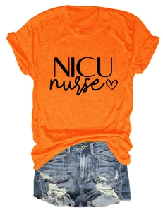 Flat lay of an orange NICU nurse T-shirt paired with distressed denim shorts on white background