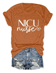 Detailed close-up of burnt orange NICU nurse cotton t-shirt with heart graphic and denim shorts