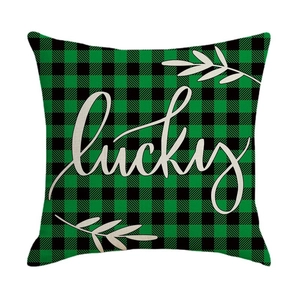 Green and black buffalo plaid St. Patrick's Day cushion cover with white lucky text
