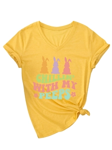 Detail of yellow V-neck T-shirt with rolled sleeves, front knot, and colorful rabbit print