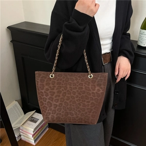 Chic leopard print tote bag with gold chain straps styled with a casual outfit