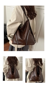 Dettaglio della borsa hobo in pelle PU marrone lucida con cerniere argentate