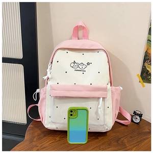 Detail of pink polka dot backpack featuring a transparent front pocket and side storage