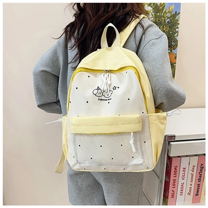 Cute yellow and white patchwork school backpack with transparent front pocket and dots
