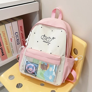 Close-up of pink school backpack with transparent PVC pocket and cartoon dog graphics