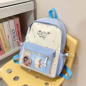 Detail of the light blue and cream school backpack with a transparent front PVC pocket