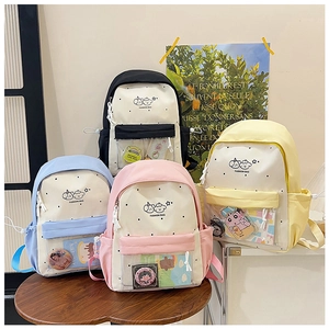 Polka dot nylon school backpacks in black, pink, blue, and yellow with clear pockets