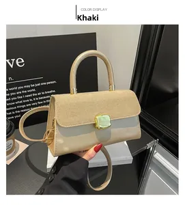 Detail view of khaki handbag featuring matte suede flap and green decorative buckle
