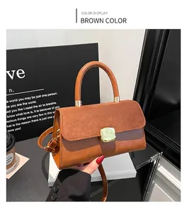 Detail of a brown vintage crossbody bag with suede flap, metal buckle, and round handle