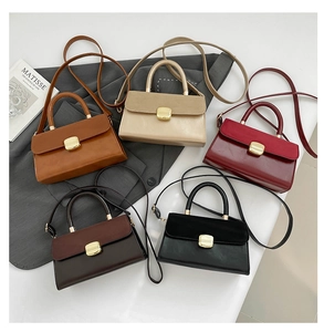 Flat lay of small square shoulder bags in caramel beige burgundy brown and black colors