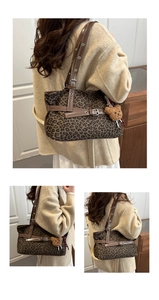 Detail of leopard print tote bag featuring a leather strap and a cute brown plush bear charm