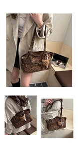 Close-up of leopard print suede tote bag with brown leather strap and plush bear charm