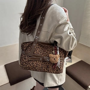 Large leopard print tote bag with brown leather straps and plush bear charm for women