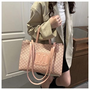 Close-up of pink tote bag with M-letter jacquard pattern and embossed logo detail