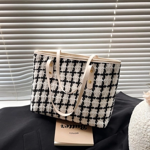 Classic black and white tweed tote bag with cream leather straps and gold rivets
