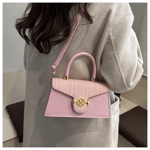 Pink lady crossbody bag with tweed texture flap and gold M-letter clasp shown on model