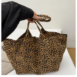 Close-up of leopard print canvas tote bag with durable handles and large capacity