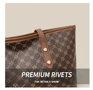 Detail shot of premium golden rivets and brown leather strap on vintage tote bag