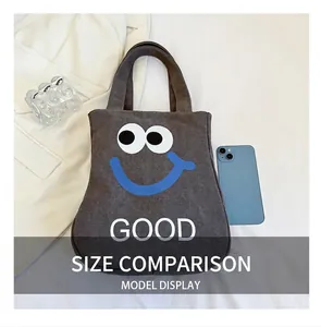 Canvas tote bag size comparison with blue smartphone on a clean white surface