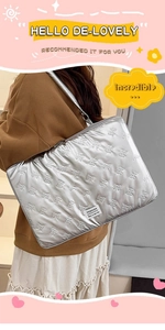 Close-up of silver quilted laptop sleeve with bow pattern and Fashion label detail