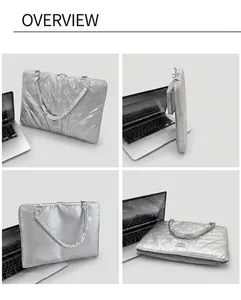 Silver quilted laptop sleeve with butterfly texture and handle on wooden desk