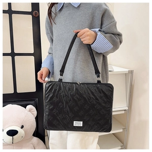Quilted 14-inch laptop shoulder bag with bow pattern and fashion label display