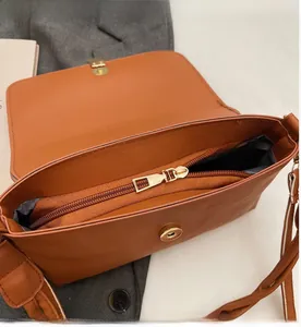 Detail of the inner compartment with a smooth gold zipper and magnetic snap closure