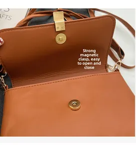 Detail of vintage brown bag showing the strong magnetic buckle and secure closing mechanism