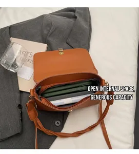 Spacious interior of caramel leather bag showing large capacity and zipper pocket