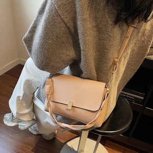 Beige faux leather crossbody bag with woven strap and gold buckle for women