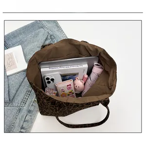 Capacity display of the leopard print tote bag showing laptop and daily essentials