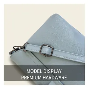 Detail of light blue leather texture with high-quality dark grey metal buckle and fine stitching