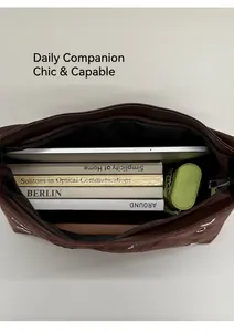 Internal view of the dark brown tote bag showing capacity for books and an umbrella