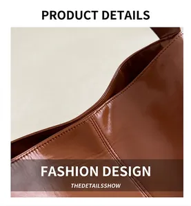 Detailed close-up of stitching and brown patent leather texture on tote bag