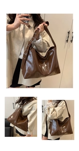 Detail of dark brown glossy hobo bag featuring wide metal eyelet straps and silver buckles