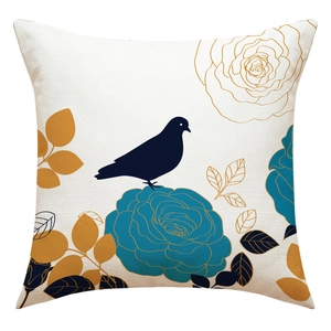 Detailed view of linen texture featuring blue bird and floral pattern on cushion cover