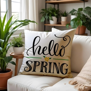 Linen sofa cushion with Hello Spring floral design on white background in living room