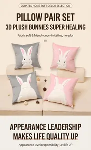 Detail of plush velvet rabbit cushion showing pink and gray bunny embroidery on sofa