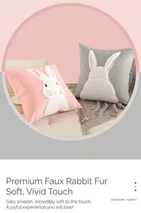Close-up of soft velvet rabbit pillows in pink and gray on a stylish sofa