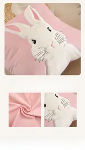 Detail of pink velvet pillow cover with 3D white rabbit embroidery and soft fabric texture