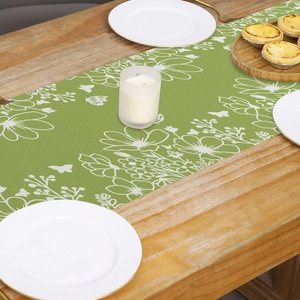 Linen style spring table runner with green base, white flowers and butterfly patterns