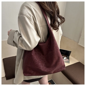 Deep burgundy leopard print tote bag shown on shoulder for daily commute style
